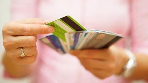 Frau hält mehrere Kreditkarten in der Hand