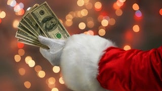 Arm vom Weihnachtsmann mit Geld