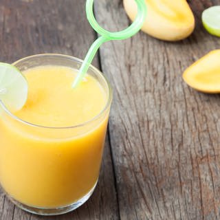 Cocktail mit Orange, Limette und Mango