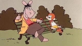 Zeichentrickfiguren Äffle und Pferdle sitzen auf einer Bank