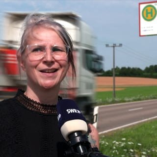 In Neresheim-Bretten wurde eine Bushaltestelle direkt an die Landstraße verlegt. Eine Anwohnerin steht an der Haltestelle und erklärt die Schwierigkeiten.