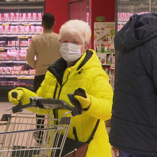 Frau mit Maske beim Einkaufen.