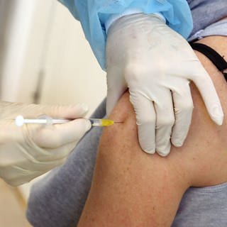 Eine Frau bekommt ihre Booster-Impfung mit dem Comirnaty-Impfstoff des Herstellers BiontechPfizer verabreicht.
